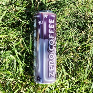 May include: A stainless steel tumbler with a black and white design featuring the words "ZERO COFFEE" and stars.