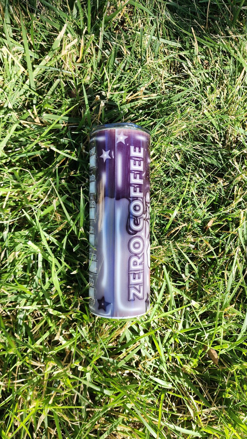 May include: A stainless steel tumbler with a black and white design featuring the words "ZERO COFFEE" and stars.