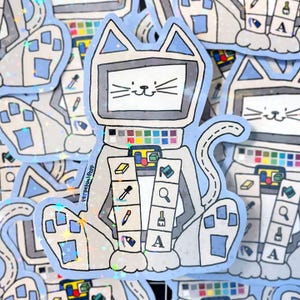 May include: A sticker featuring a cat-shaped computer with a screen face, a color palette, and design tool icons. The cat is light gray with blue accents and a white face. The sticker has a holographic, glittery effect.