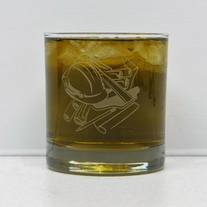 May include: A clear glass tumbler with a design etched into the side. The design features a hard hat, pencils, and rulers. The tumbler is filled with a brown liquid and ice.