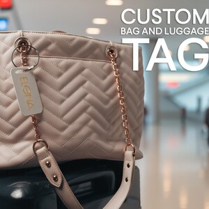 May include: A pale pink tote bag with a quilted herringbone pattern and rose gold chain straps. A white rectangular luggage tag with the name ELENA printed in gold is attached to the bag. The text CUSTOM BAG AND LUGGAGE TAG appears above.