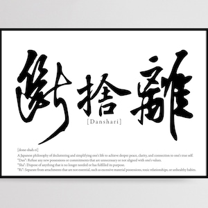 May include: Black and white print of the Japanese word "Danshari" meaning "decluttering" or "simplifying" with the English translation and definition below. The definition explains the Japanese philosophy of decluttering and simplifying one's life to achieve deeper peace, clarity, and connection to one's true self.