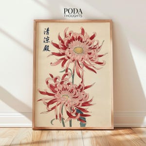 May include: Framed botanical print featuring two large, detailed chrysanthemum flowers in shades of red and pink, with yellow centers. The artwork has Japanese text and is set against a cream background, in a wooden frame.