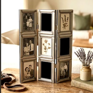 May include: A silver-toned, three-panel folding picture frame featuring nine rectangular openings. The frame displays various black and white vintage-style photographs of families and botanical illustrations of flowers within its structured borders.