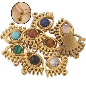 May include: Assortment of gold-toned eye charms with various colored gemstone accents. Each charm features a detailed eye design with a central gemstone and a fringe of small beads.