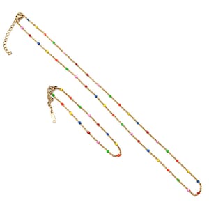 May include: A gold chain necklace with colorful beads. The necklace is layered with a shorter chain. The beads are red, orange, yellow, green, blue, and purple.