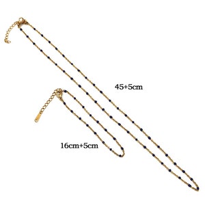 May include: Two gold chains with blue beads. The longer chain measures 45 inches plus a 5 inch extension. The shorter chain measures 16 inches plus a 5 inch extension.