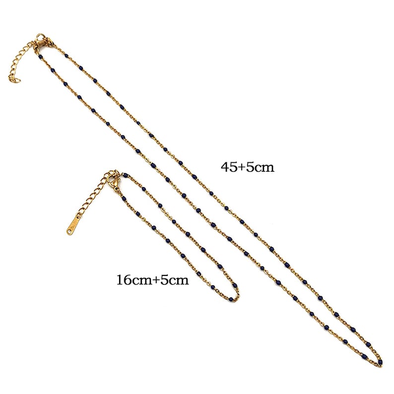 May include: Two gold chains with blue beads. The longer chain measures 45 inches plus a 5 inch extension. The shorter chain measures 16 inches plus a 5 inch extension.