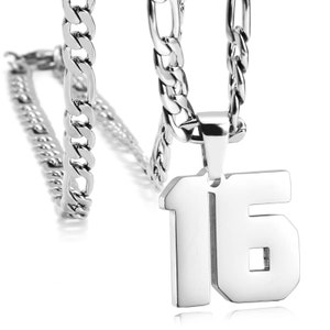 May include: A silver chain necklace with a silver pendant shaped like the number 16.