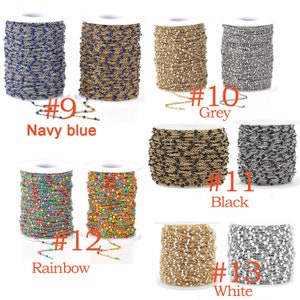 May include: Spools of chain with different colored beads. The chain is available in navy blue, grey, black, rainbow, and white. The spools are labeled with numbers 9 through 13.