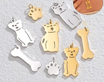 May include: A set of nine silver and gold metal charms featuring various dog and cat designs. The charms include a paw print, a bone, a cat sitting, a dog sitting, and a cat standing. The charms are perfect for adding a personalized touch to necklaces, bracelets, or keychains.