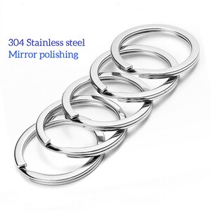 May include: Five silver key rings made of 304 stainless steel with a mirror polish finish.