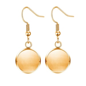 May include: A pair of gold-tone earrings with round, smooth, blank discs. The earrings have a simple, elegant design.