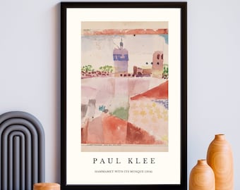 May include: A framed print of a watercolor painting by Paul Klee titled "Hammamet with its Mosque (1914)". The painting depicts a colorful cityscape with a mosque in the center.