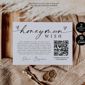 May include: A white card with the words "honeymoon wish" in elegant script, accompanied by a QR code and text. The card is set against a neutral background with decorative elements, including a wax seal and a gold-colored tool.