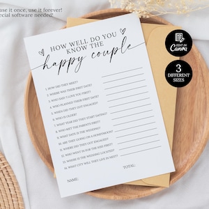 May include: A white card with the text "How Well Do You Know the Happy Couple" in black script, with fill-in-the-blank questions. The card is on a wooden plate with a tan envelope and a black circle that says "3 Different Sizes".