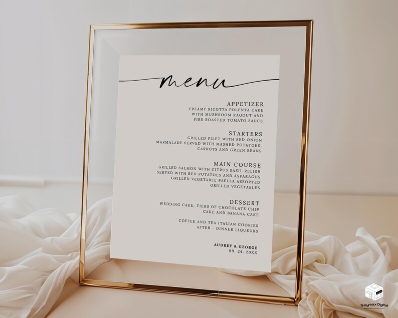 Op de afbeelding: Een ingelijst menu met een goudkleurig metalen frame. Het menu is gedrukt op wit papier en heeft bovenaan een handgeschreven "menu". Het menu bevat voorgerechten, voorgerechten, hoofdgerechten en desserts. De namen "Audrey & George" en een datum staan onderaan.