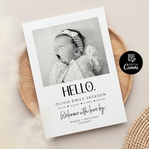 Op de afbeelding: Zwart-witte geboortekaart met een foto van een babymeisje. De kaart zegt "HELLO." en bevat de naam van de baby, de geboortedatum, het gewicht in kilogram, de lengte in centimeters en de tijd van geboorte. De kaart zegt ook "Welcome with love by." gevolgd door de namen van de ouders.