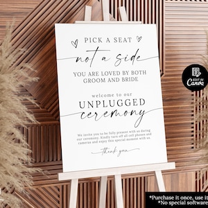 May include: A white sign on a wooden easel with the text "Pick a seat, not a side" in black script. The sign welcomes guests to an unplugged ceremony and asks them to turn off phones and cameras.
