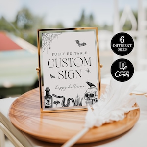 May include: A gold-framed sign with the text "CUSTOM SIGN" and "happy halloween" in black. The sign features Halloween-themed illustrations, including a spiderweb, bat, and skull. Two black circles indicate "6 DIFFERENT SIZES" and "EDIT IN Canva".