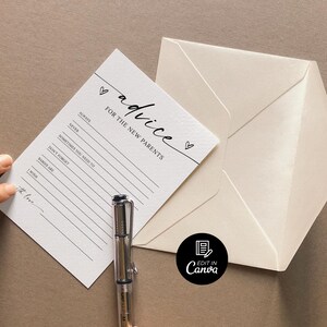 May include: A white card with black text that reads "advice for the new parents" with a heart symbol. The card has lines for writing advice. A pen is lying on top of the card.