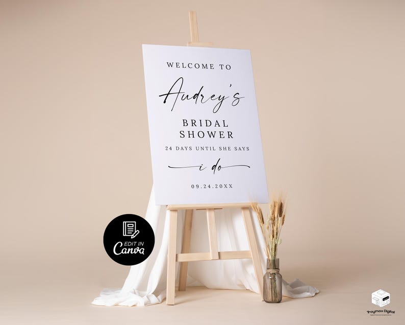 Puede incluir: Un letrero blanco sobre un caballete de madera con el texto "Welcome to Audrey's Bridal Shower" en elegante escritura negra. El letrero tambi&eacute;n incluye la fecha "09.24.20XX" y la frase "24 d&iacute;as hasta que diga que s&iacute;."