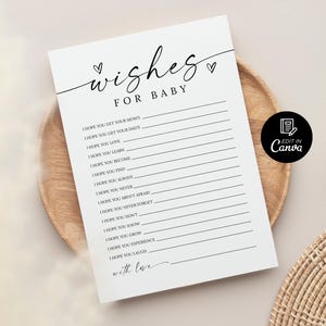 K&ouml;nnte beinhalten: Eine wei&szlig;e Babyparty-Spielkarte mit den Worten "wishes for baby" in eleganter Schrift. Die Karte enth&auml;lt Aufforderungen f&uuml;r die G&auml;ste, ihre W&uuml;nsche aufzuschreiben. Die Karte liegt auf einem Holztablett.