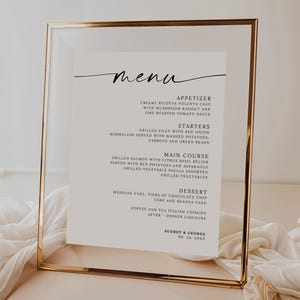 May include: A gold-framed menu with a white background and black text. The menu lists appetizers, starters, main course, dessert, and the names Audrey & George with the date 09. 24. 2013.
