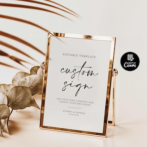 May include: A gold-framed sign with the text "EDITABLE TEMPLATE custom sign ADD YOUR OWN CONTENT AND CREATE YOUR OWN SIGNS AUDREY & GEORGE 24.09.2013" printed on a white background. The sign is on a stand and is ready to be customized.