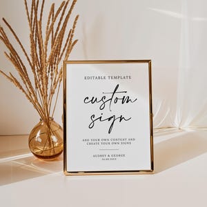 May include: Editable template sign with gold frame and the text "custom sign" in black script font. The text below reads "Add your own content and create your own signs" followed by "Audrey & George 24.08.20XX".