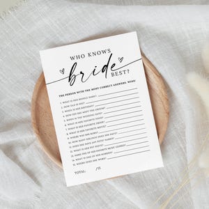May include: A printable bridal shower game with the title "Who Knows Bride Best?"  The game has 15 questions about the bride, with lines for guests to write their answers. The person with the most correct answers wins.