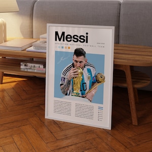 May include: A poster featuring a photo of Lionel Messi holding the World Cup trophy. The poster has a blue background with the text "Messi" in bold white letters and "Argentina National Football Team" in smaller white letters. The poster also includes a list of Messi's achievements with the Argentina National Team.