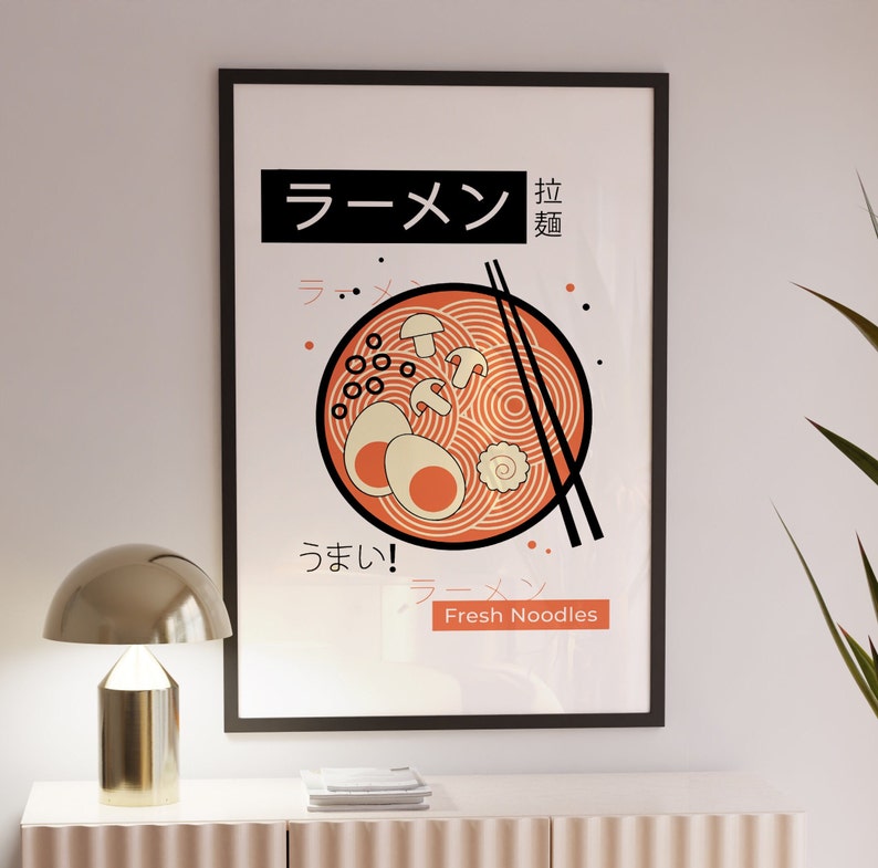 Puede incluir: Un p&oacute;ster enmarcado en negro con una ilustraci&oacute;n roja y blanca de un taz&oacute;n de fideos ramen. El texto en el p&oacute;ster dice "Ramen" en caracteres japoneses y "Fresh Noodles" en ingl&eacute;s.