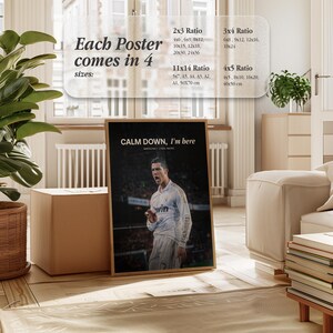 May include: A framed poster with a soccer player in a white jersey, with the text "CALM DOWN, I'm here." The poster is displayed in a room with a wooden floor and a plant. The poster comes in 4 sizes: 10x15cm, 15x23cm, 20x30cm, 25x38cm, 30x46cm, 51x76cm, 61x91cm, 13x18cm, A5, A4, A3, A2, A1, 50x70cm, 15x20cm, 23x30cm, 30x41cm, 46x61cm, 10x13cm, 20x25cm, 25x51cm, 102x127cm.