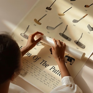 Hands rolling up vintage golf putter poster print for rustic industrial home decor.
