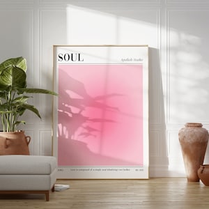 May include: A framed art print with the word "SOUL" in a minimalist font. The artwork features a gradient pink background with a plant shadow. The text "Apolioh Studio", "AURA", and a quote are also visible.