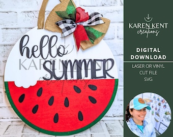 May include: A round wooden door hanger with a watermelon design. The top half is white with the text "hello summer" in black. The bottom half is red with black seeds and a green rind. A black and white checkered bow with green and red accents is attached to the top.