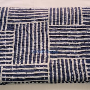 May include: A blue and white kantha quilt with a geometric pattern. The quilt is made of cotton and is hand-stitched.