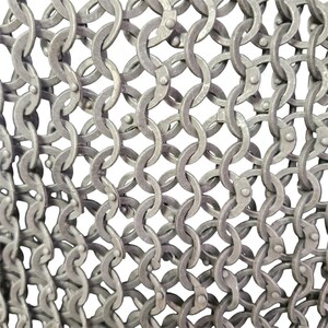 May include: Close-up of a silver chainmail, a type of armor made of interlocking metal rings.