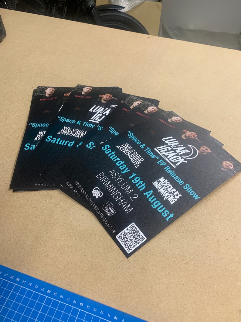 May include: Black and white flyers advertising a music event called "Lunar Hijack" featuring the text "Space & Time" EP Release Show. The event will take place on Saturday, August 19th at Asylum 2 in Birmingham. A QR code is included on the flyer.