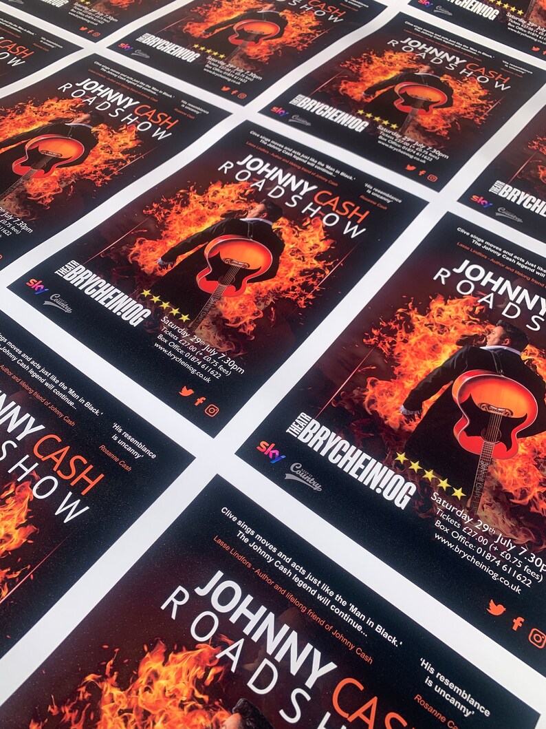May include: A black and white poster with a fiery background and a silhouette of a man playing a guitar. The poster advertises a Johnny Cash Roadshow at the Brycheiniog Theatre in Wales. The poster includes the date and time of the show, ticket prices, and contact information.