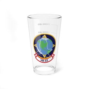 May include: A clear glass pint glass with a navy blue, yellow, and green emblem featuring a globe and a compass. The text "VR-52" is printed in red on a white banner below the emblem.