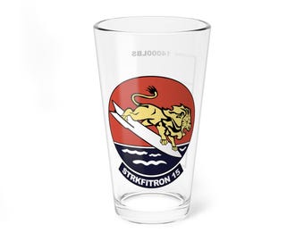 May include: A clear glass pint glass with a red, white, and blue graphic of a lion riding a surfboard with the text "STRKFITRON 15".
