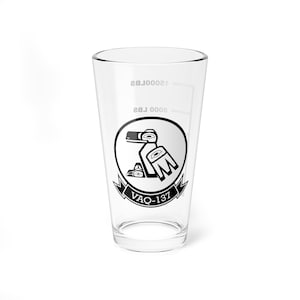 May include: A clear glass pint glass with a black and white graphic of a bird with the text "VAQ-137" printed on the side. The glass has markings for 8 oz and 12 oz.