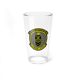 May include: A clear glass pint glass with a yellow and black logo that says "Black Knights" and "VMFA 314".
