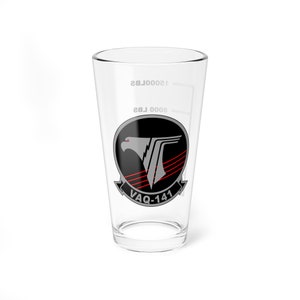 May include: A clear glass pint glass with a black and silver squadron emblem featuring a red-eyed eagle and the text "VAQ-141".