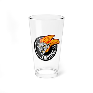 May include: A clear glass pint glass with a black and white circular logo featuring a cartoon creature with red and yellow wings. The logo reads "Fighting 33".