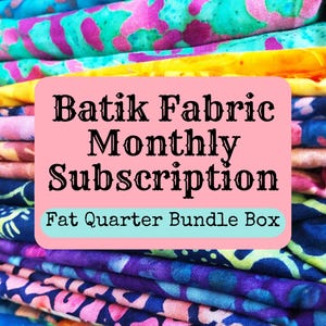 May include: A stack of colorful batik fabric fat quarters in a variety of patterns. The fabric is arranged in a pile and has a text overlay that reads "Batik Fabric Monthly Subscription Fat Quarter Bundle Box".