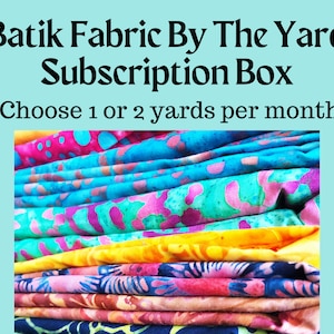 May include: A stack of colorful batik fabric in various patterns, including pink, blue, yellow, and green. The fabric is folded neatly and is available in a subscription box. Choose 1 or 2 yards per month.