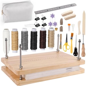 May include: A light-colored wooden book press with metal hardware, surrounded by various craft supplies. Includes spools of thread, a ruler, scissors, and a white zippered pouch. A comprehensive kit for bookbinding.